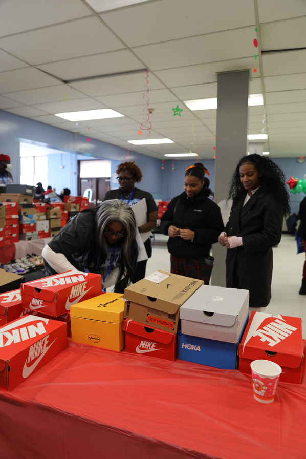 Volunteers sorting stacks of shoeboxes on a table at a collection day.